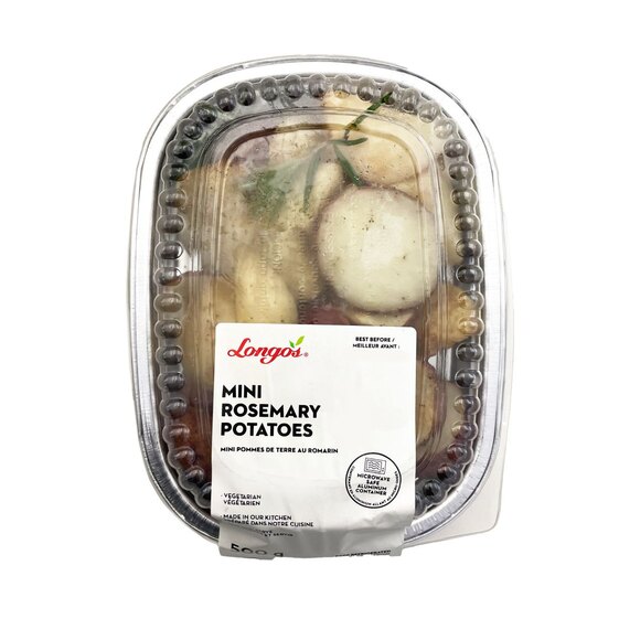 Mini rosemary potatoes in a sealed ready-to-heat container, roasted potato side dish with rosemary seasoning.